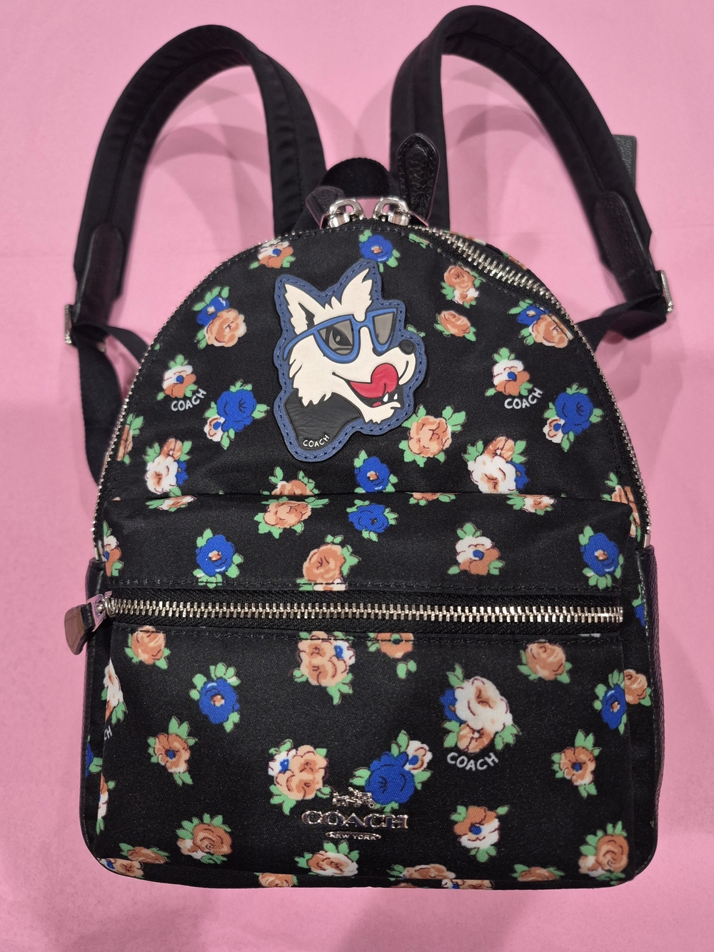 Coach Mini Charlie Black Tea Rose Floral Print Backpack with Wolf Patch.